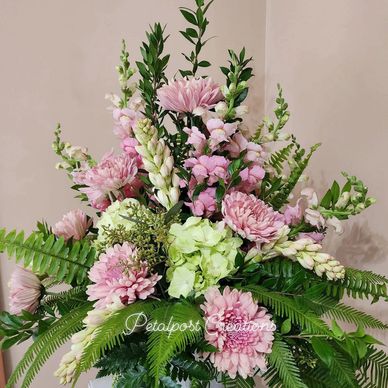 Green hydrangea, pink cremones and fern flower arrangement