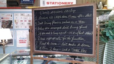 Chalkboard with etiquette rules displayed in a stationery store.