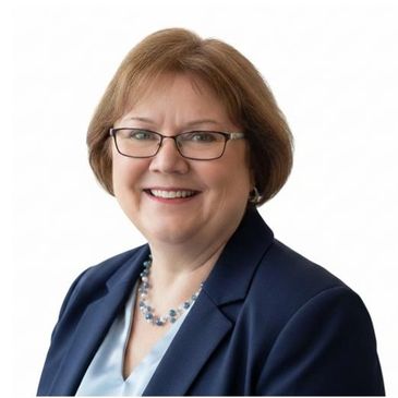 Professional portrait of a smiling woman with glasses and a navy blazer.