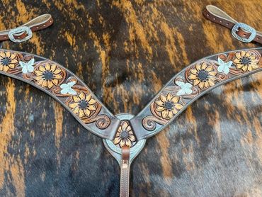 Leather horse breast collar with floral and butterfly designs.