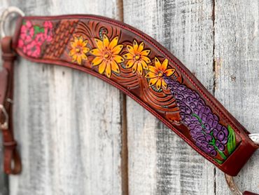 Leather strap with colorful floral designs including yellow and purple flowers.
