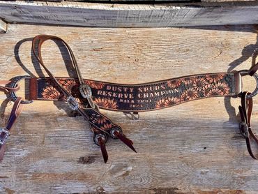 Ornate leather horse tack labeled Dusty Spurs Reserve Champion 2024.