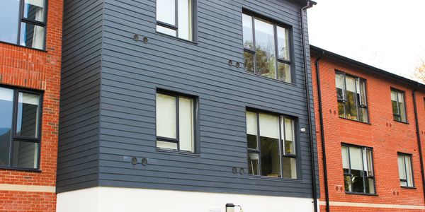 Modern building with brick and grey siding.