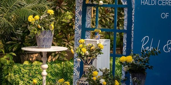 Elegant blue and white floral decor for a Haldi ceremony celebration.