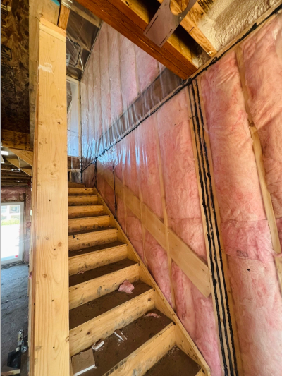 Wooden stairs under construction with insulation.