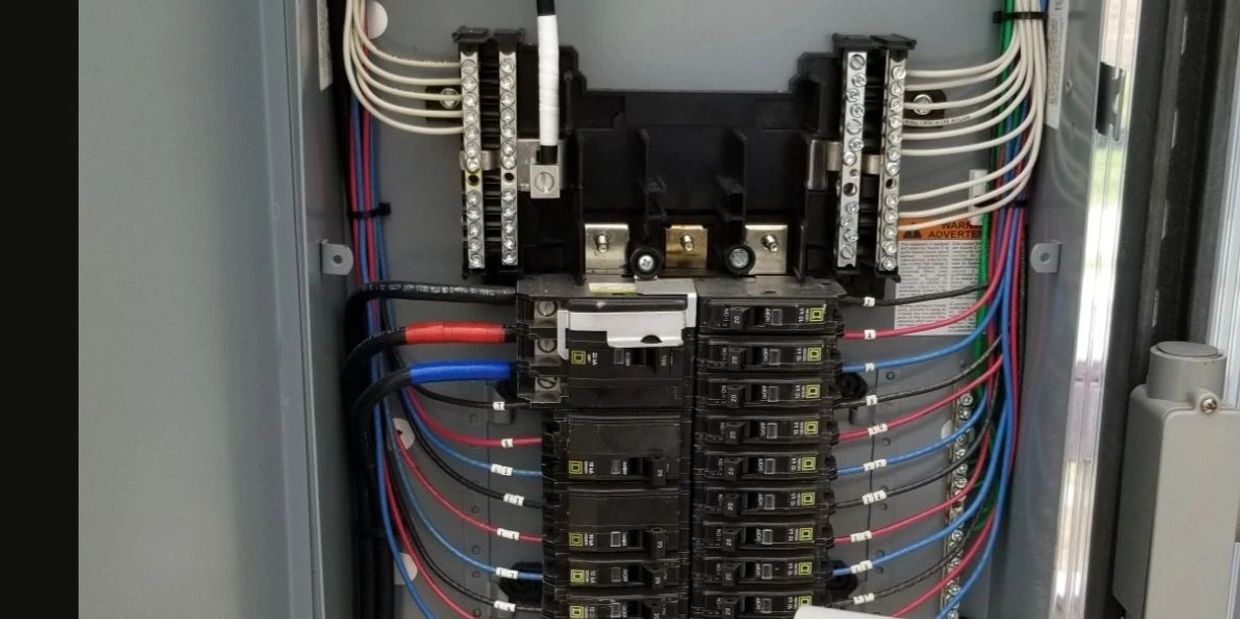 A neatly organized electrical breaker panel with labeled wires.