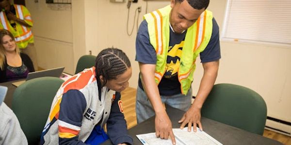 Two men in a meeting reviewing a map together.