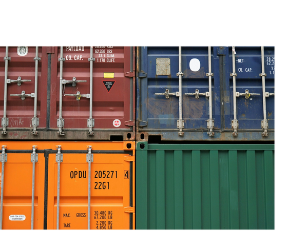 Four colorful stacked shipping containers in red, blue, orange, and green.