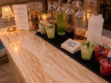 Bar with bottles and cocktails ready to serve.
