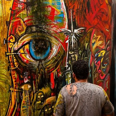 Artist observing vibrant abstract eye mural.