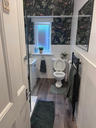 Full bathroom refurb with walk in shower, feature wall paper and vinyl flooring 