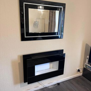 Wall mounted electrical fire and mirror hung by our professional Handyman in the East End of Glasgow