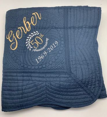 navy quilt with married name and anniversary date of couple 