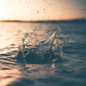 Water splash captured at sunset on a calm sea