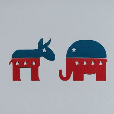 Cutout symbols of Democratic donkey and Republican elephant with stars