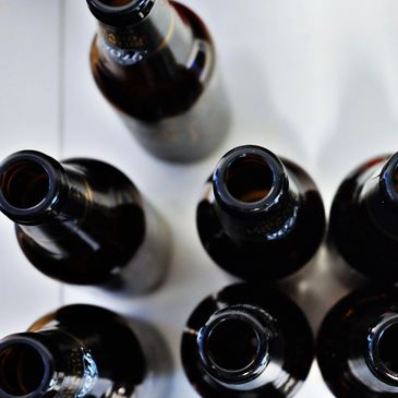 Top view of multiple empty brown glass bottles on a white surface