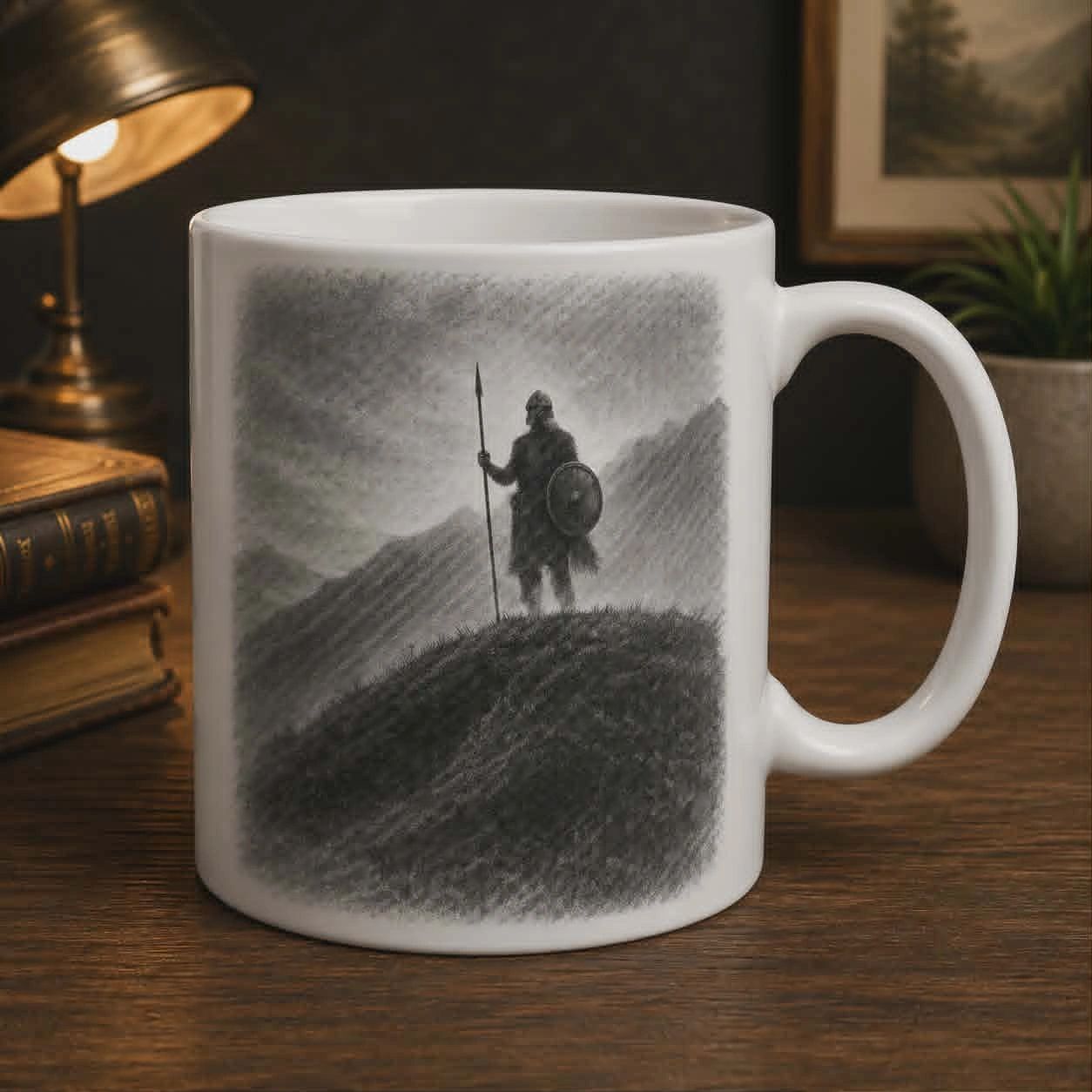 White mug with a black and white warrior illustration on a hill.