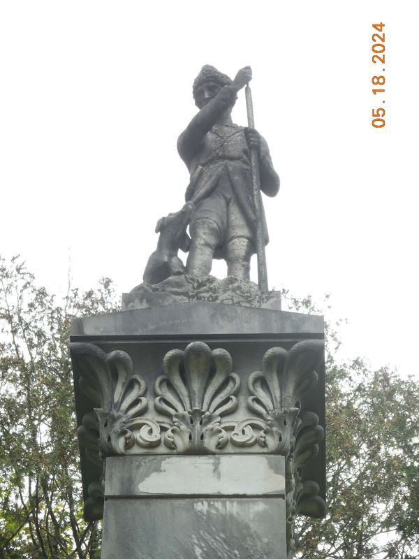 Statue of Leatherstocking and dog Hector at top of  Cooper Monument before cleaning