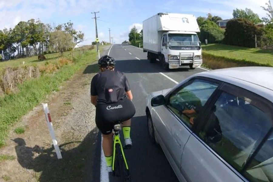 car close to cyclist
