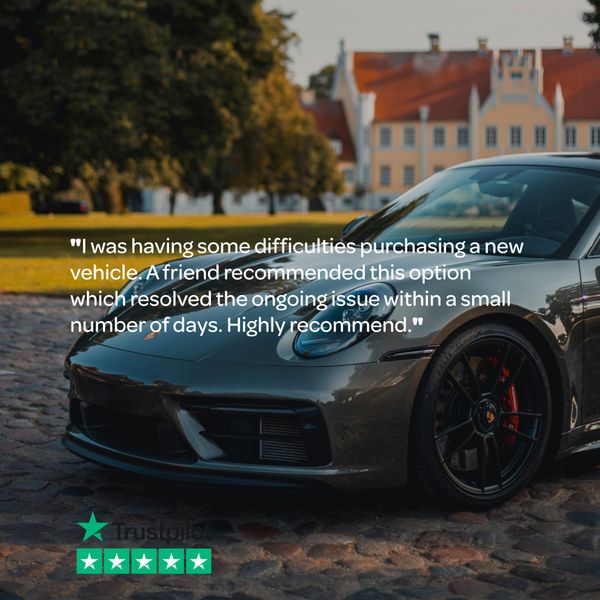 A sleek black sports car parked on a cobblestone street with a glowing customer review overlay.