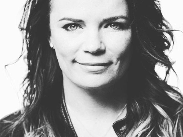 Black and white close-up portrait of a woman with a slight smile.