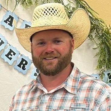 Man in a straw cowboy hat and plaid shirt.