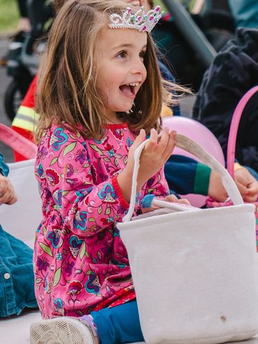 A joyful little girl with a tiara.