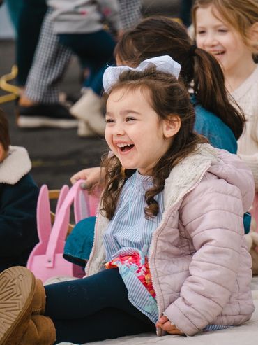 Happy little girl laughing outdoors.