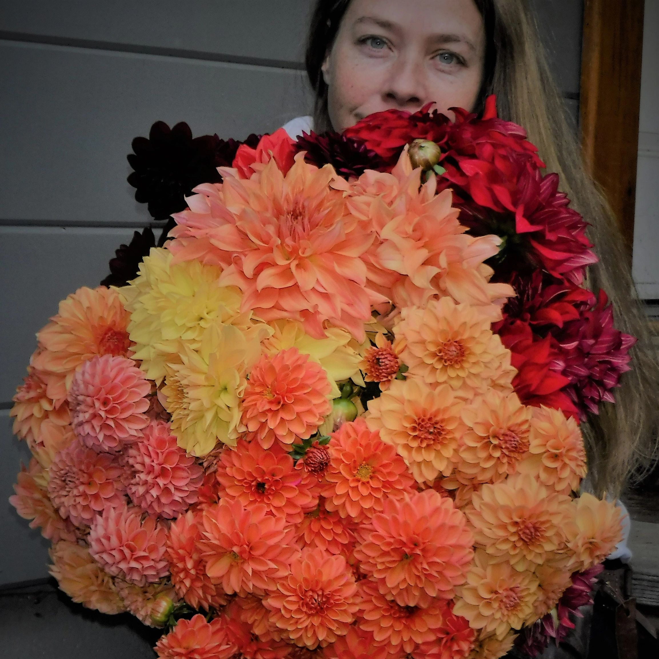 woman holding an armload of flowers