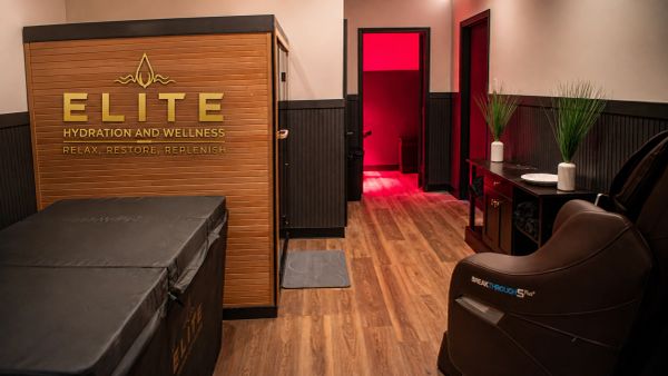 Modern wellness center interior with wooden flooring and red-lit room.