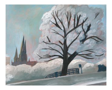A large tree in front of a church on a foggy day.