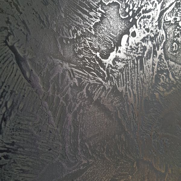 Close-up of textured metallic surface with intricate patterns.