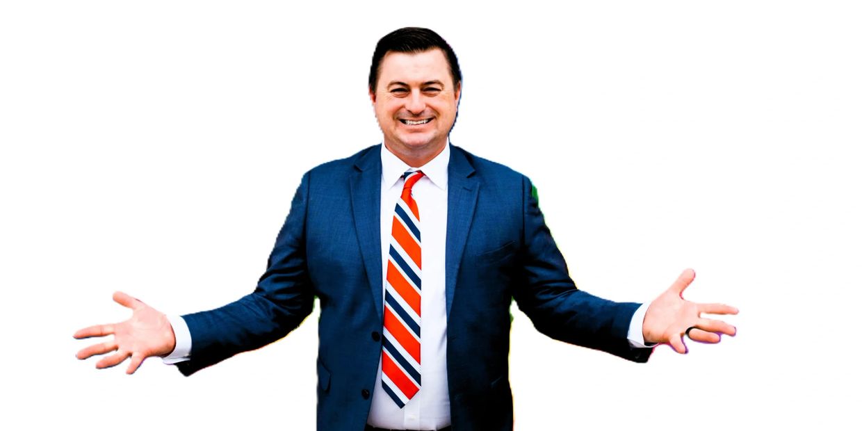Smiling man in blue suit with striped tie spreading his arms wide.