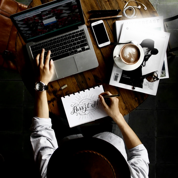 stock image of person working with laptop and coffee