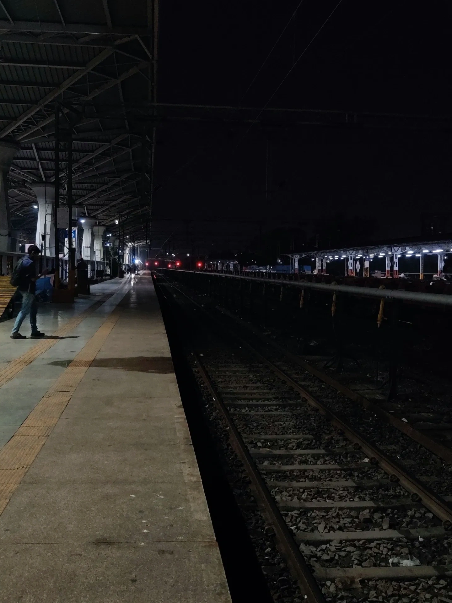 Photo of a train station platform at night. By Rini Rajendran on Unsplash