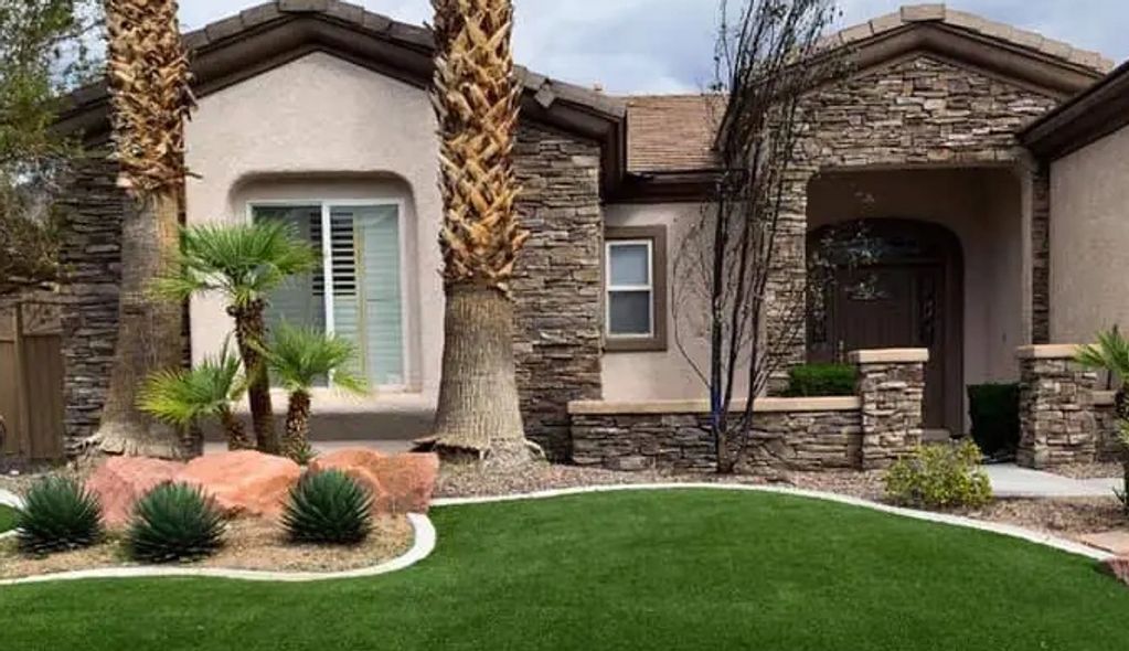 Front yard design with courtyard entry way with columns. Veneer stone finish, turf, plants, gravel