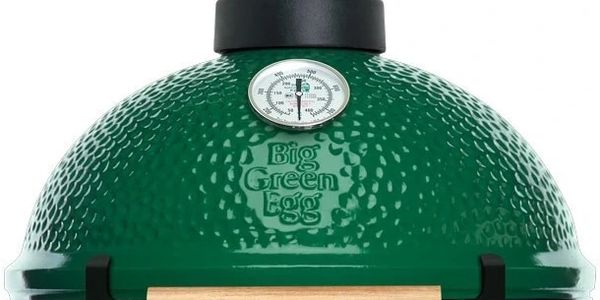 Close-up of a Big Green Egg ceramic grill with temperature gauge.