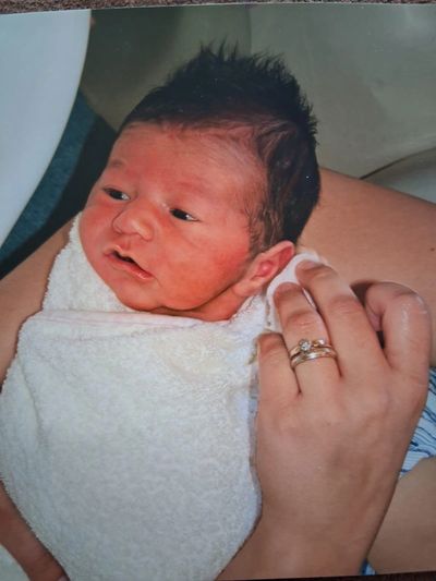 Newborn being held by mother
