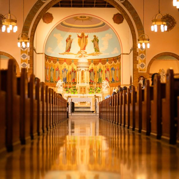 Interior of a church with altar and religious paintings.
