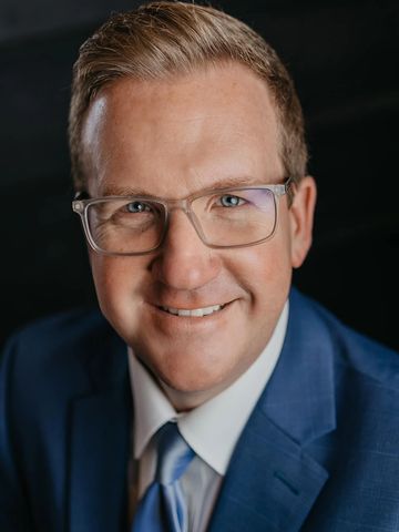 headshot photo of man in suite