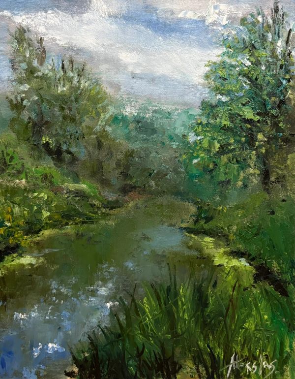 A serene river surrounded by lush greenery under a partly cloudy sky.
