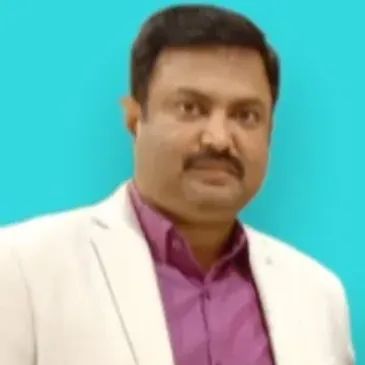 Portrait of a man in a white blazer and purple shirt.