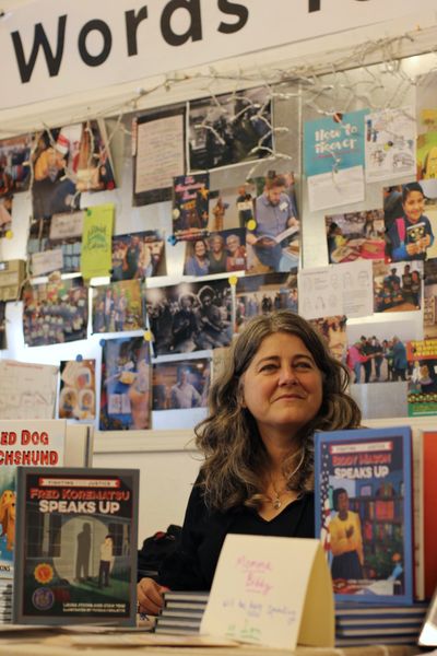 Photo by Janine Macbeth of Laura Atkins with her books