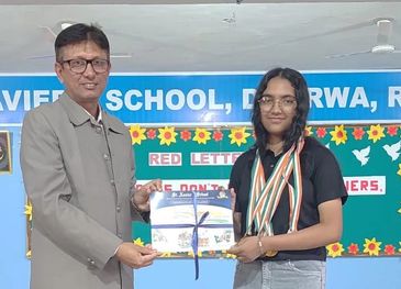 A man awards a young girl with certificates and medals at a school event.