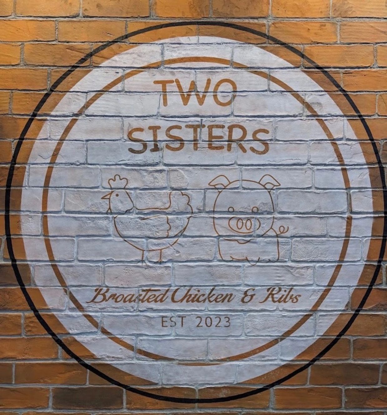 Logo of Two Sisters, broasted chicken and ribs.