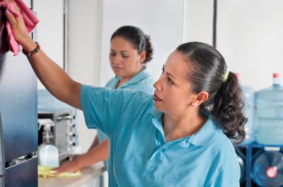 people cleaning an office area