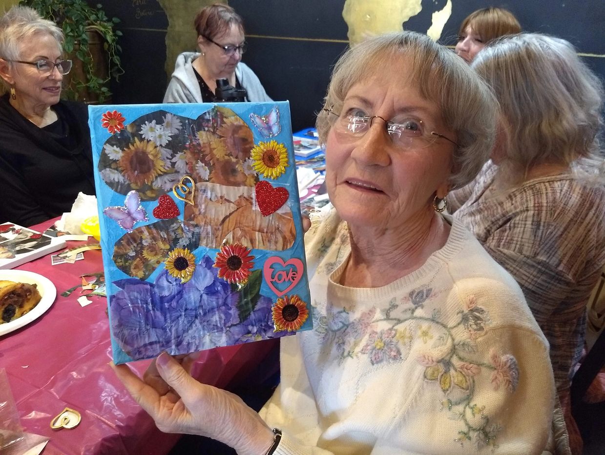 Client displays her life experience collage at a Senior Outing.
