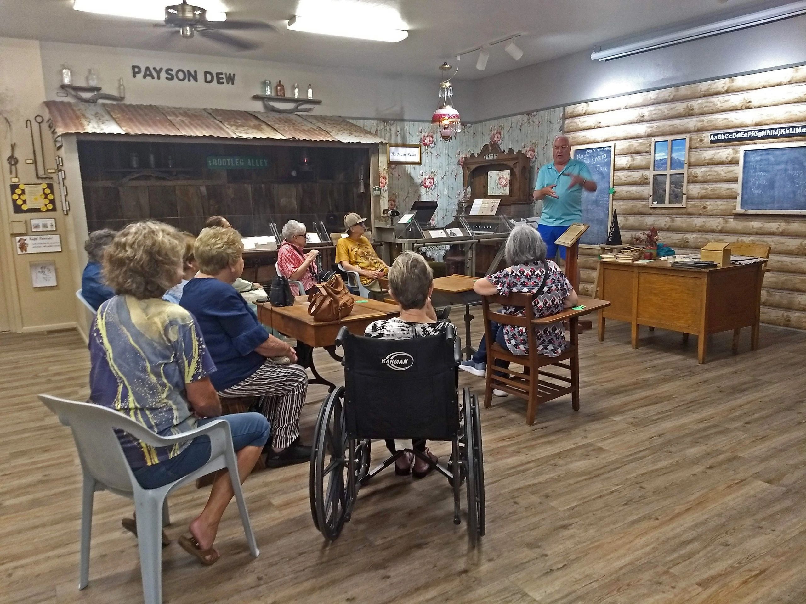 Clients and volunteers learn about pioneer ways while visiting the Zane Grey Museum in Payson.
