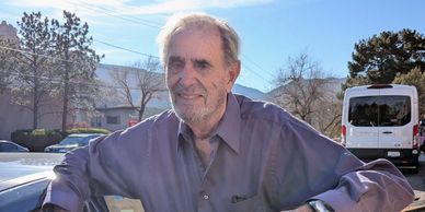 Driver, Dr. Ganelin beside his open car door.