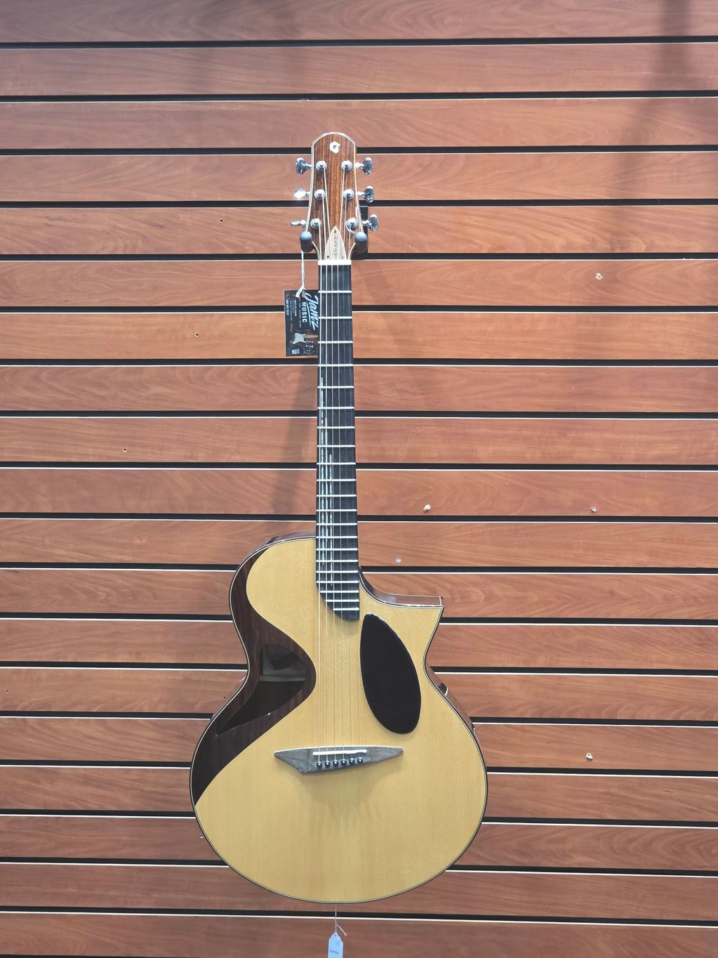 A stylish acoustic guitar with unique cutout design.